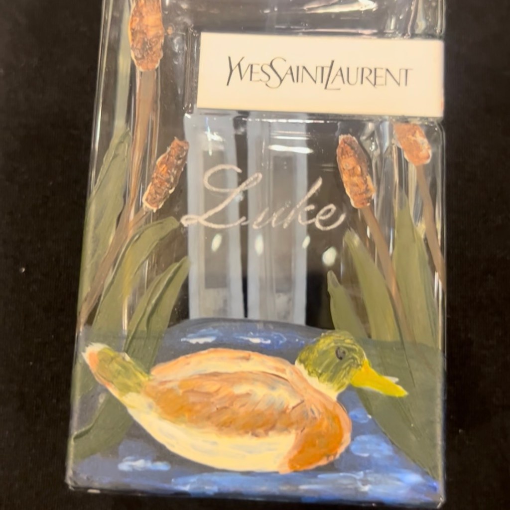 Yves Saint Laurent Libre perfume bottle engraved with the name Luke and hand painted with a duck and reeds during a live personalization event at Nordstrom Houston
