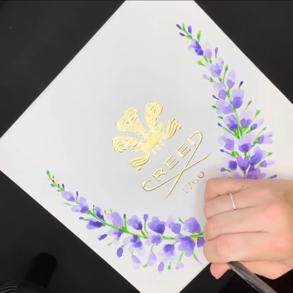 This image features a custom wedding invitation suite designed for Heather and Trey, presented inside a navy laser cut floral invitation jacket. The intricate lace style jacket creates a romantic and elegant frame for the minimalist white cards. The suite includes calligraphy text and a custom illustrated venue card featuring the historic 1940 Air Terminal Museum in Houston. The laser cut pocket and flap details are the signature design elements of this suite, offering a refined and modern way to present multiple pieces within a single cohesive jacket. Created by Wofford Calligraphy.