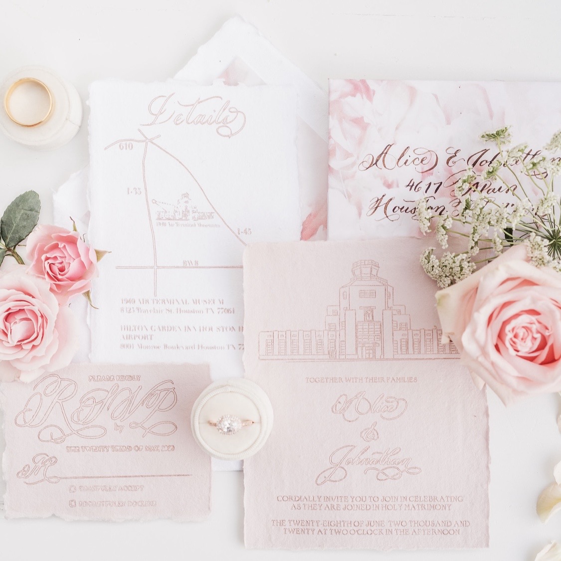 Handmade blush wedding invitation suite with gold foil calligraphy and an illustrated 1940s Air Terminal Museum design by Wofford Calligraphy, styled with roses and cotton paper details.