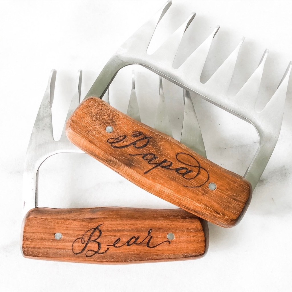 Pair of stainless steel BBQ bear claws with engraved wooden handles reading Papa and Bear, hand burned by Wofford Calligraphy as a personalized grilling gift.