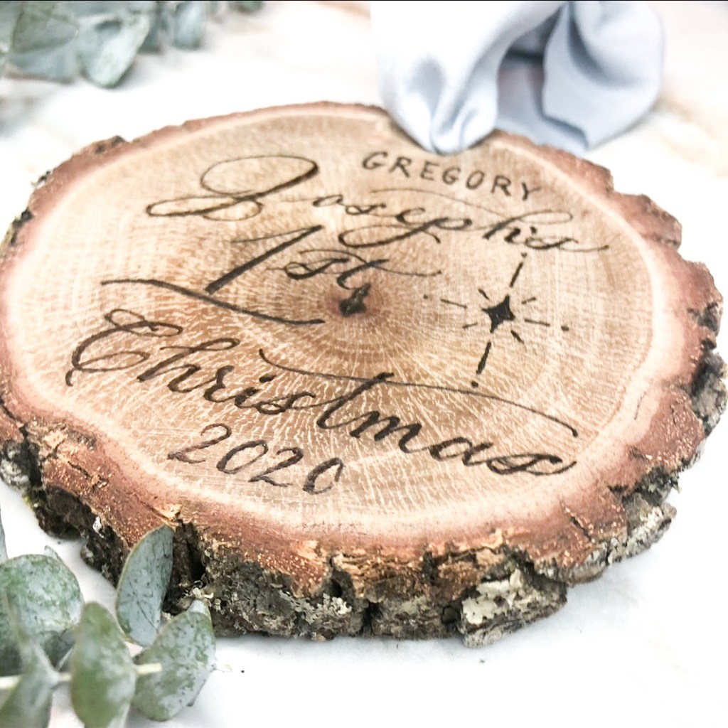 Wood burned oak slice Christmas ornament engraved with Gregory Joseph’s 1st Christmas 2020, created as a personalized baby’s first Christmas keepsake by Wofford Calligraphy.