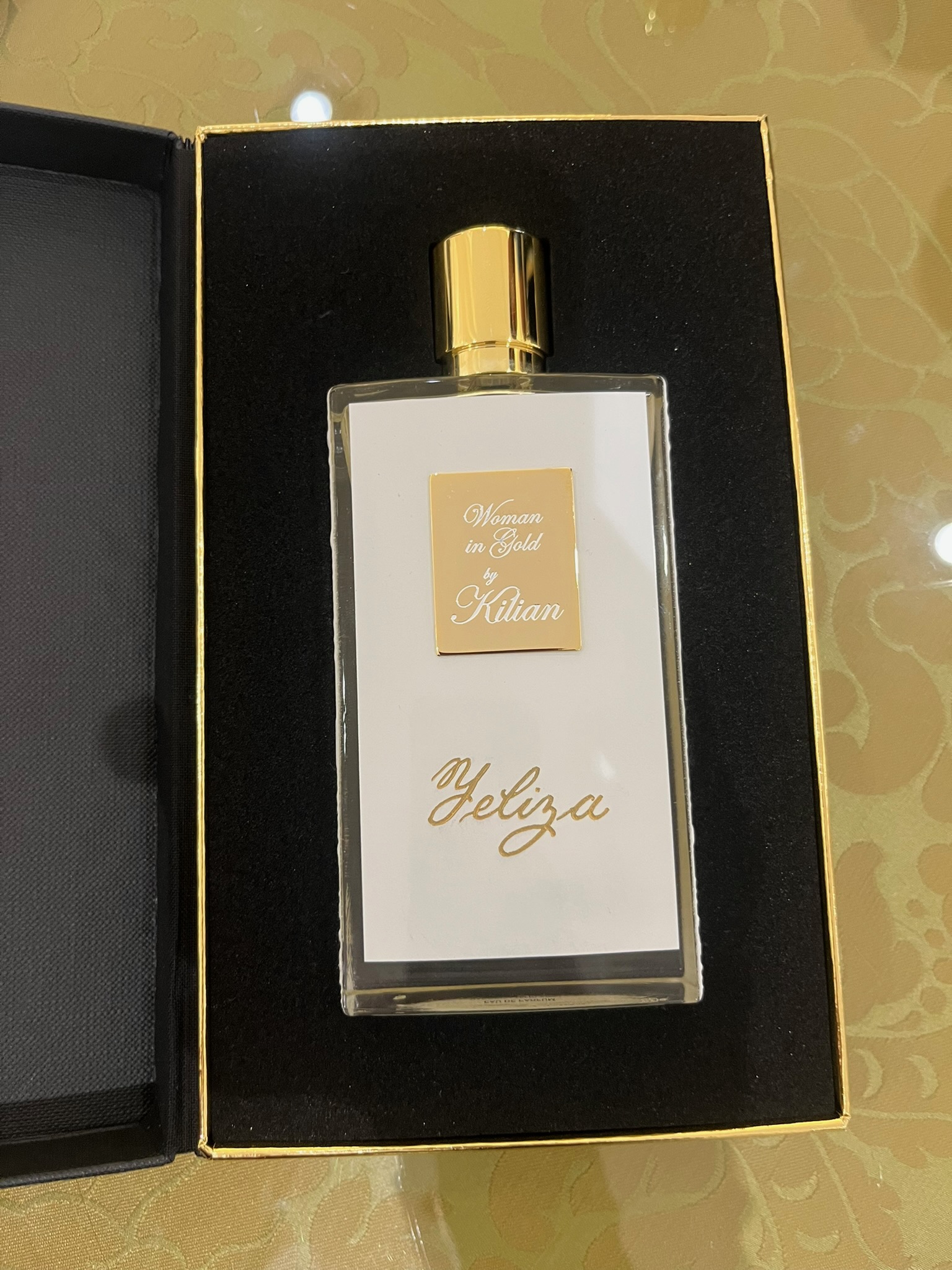 Kilian Paris Woman in Gold fragrance bottle engraved with the name Yaliza in gold inlay by Wofford Calligraphy during a Kilian Paris personalization event.