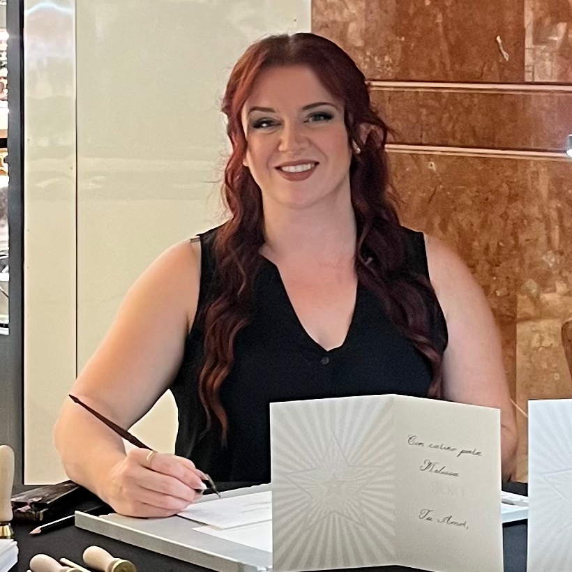 Jessica Wofford of Wofford Calligraphy preparing to write live dip pen calligraphy during a Dior Christmas card and wax seal event
