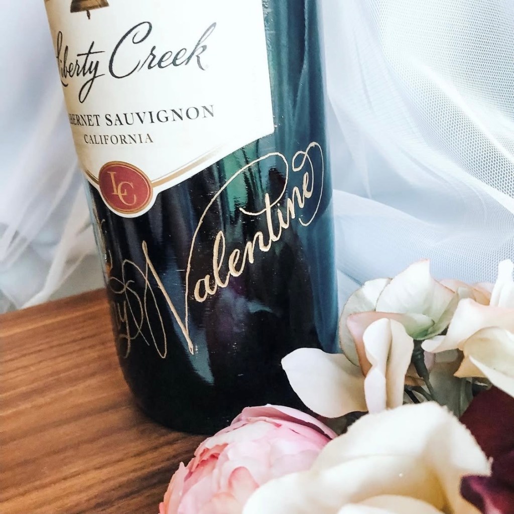 Liberty Creek wine bottle engraved with “Happy Valentine’s” in gold calligraphy, showcasing personalized wine bottle engraving for Valentine’s Day gifts.