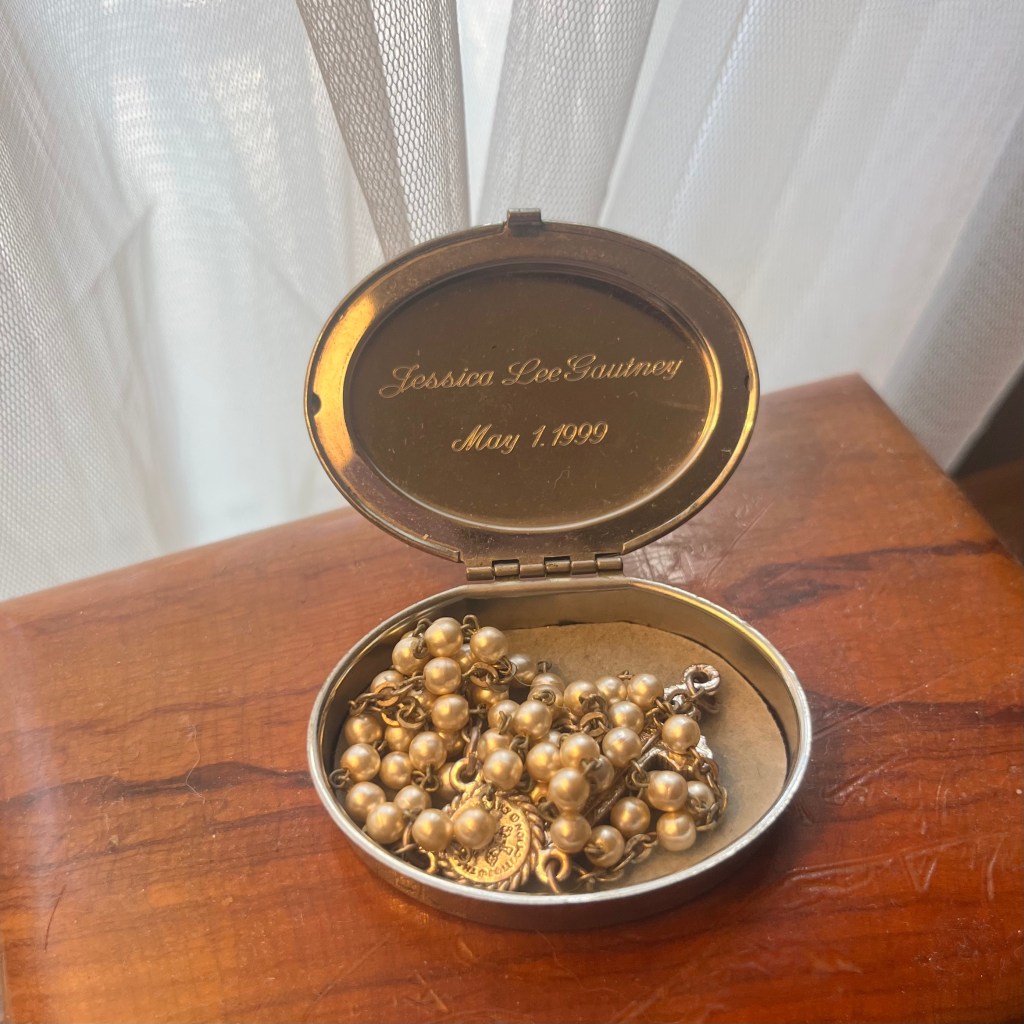 Engraved rosary box with name and date inside lid holding gold rosary, First Holy Communion gift