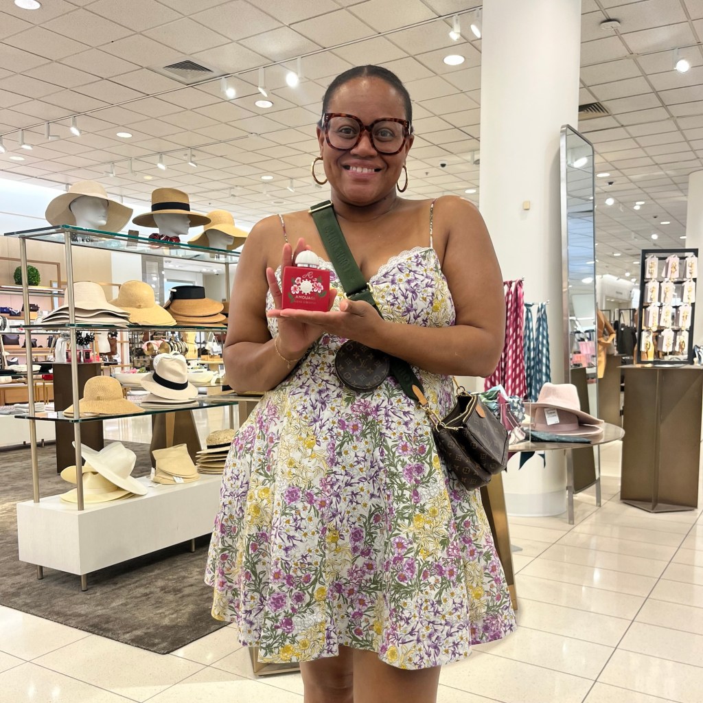 Customer holding personalized hand painted Amouage perfume bottle at live personalization event at Nordstrom Galleria Houston