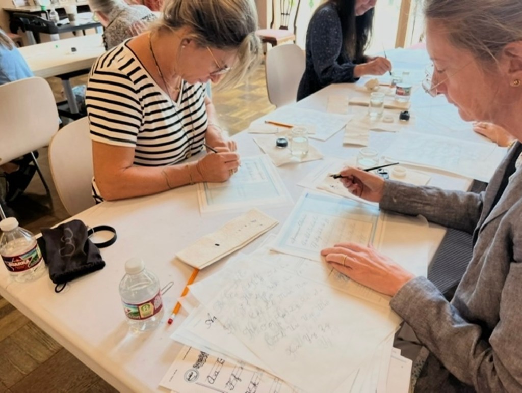 Students practicing calligraphy during workshop at Rienzi Museum Houston led by professional calligrapher