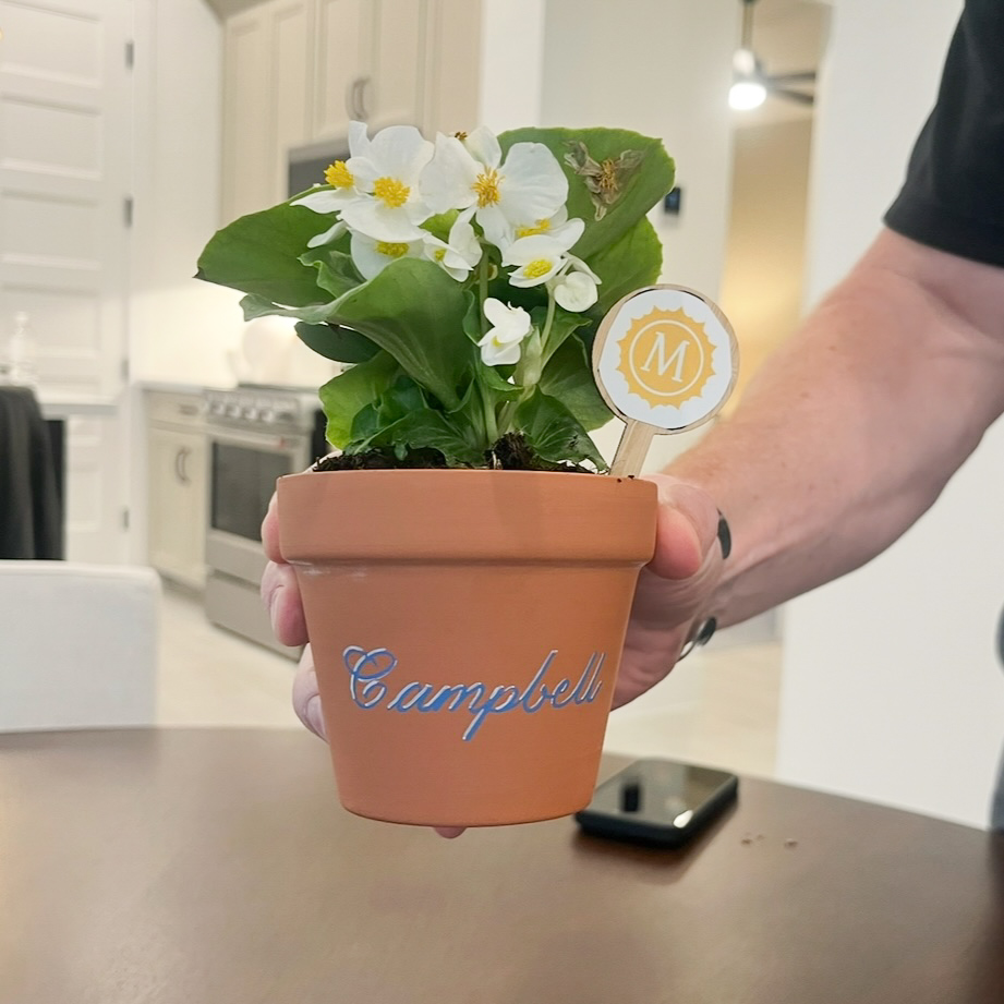 Personalized terra cotta pot with name Campbell in blue and white calligraphy for desk gift at Houston event
