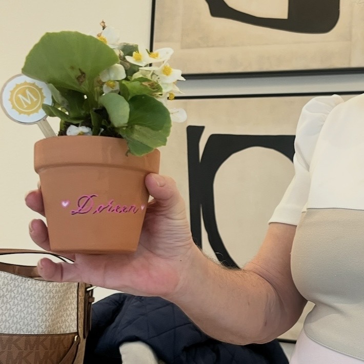 Personalized terra cotta pot with name Doreen in pink calligraphy with heart accents at Houston live event