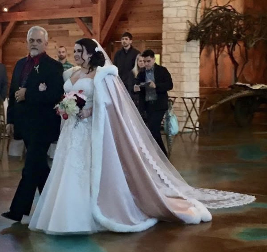 Bride walking down the aisle with her father at her wedding ceremony, sharing a meaningful father-daughter moment before the ceremony.