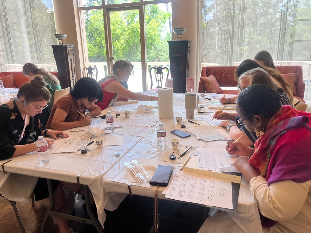 Students learning beginner pointed pen calligraphy during a workshop taught by Houston calligrapher Jessica Wofford at the Museum of Fine Arts, Houston Rienzi.