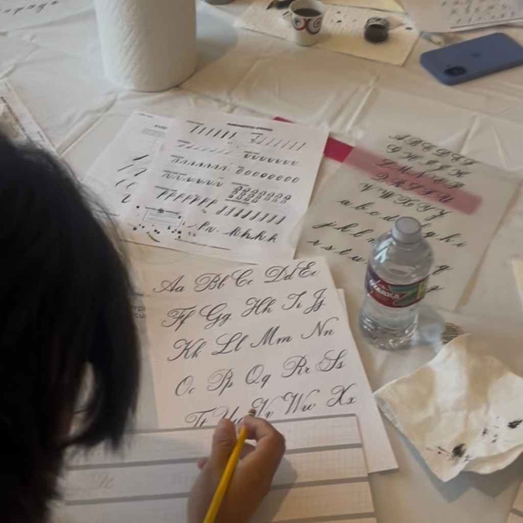 Student practicing pointed pen calligraphy during a beginner calligraphy workshop at the Rienzi Museum of Fine Arts in Houston.
