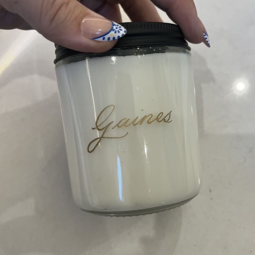 Personalized scented candle engraved live with the name Gaines in gold at the Trilogy by Shea Homes Grand Opening in Conroe, Texas.